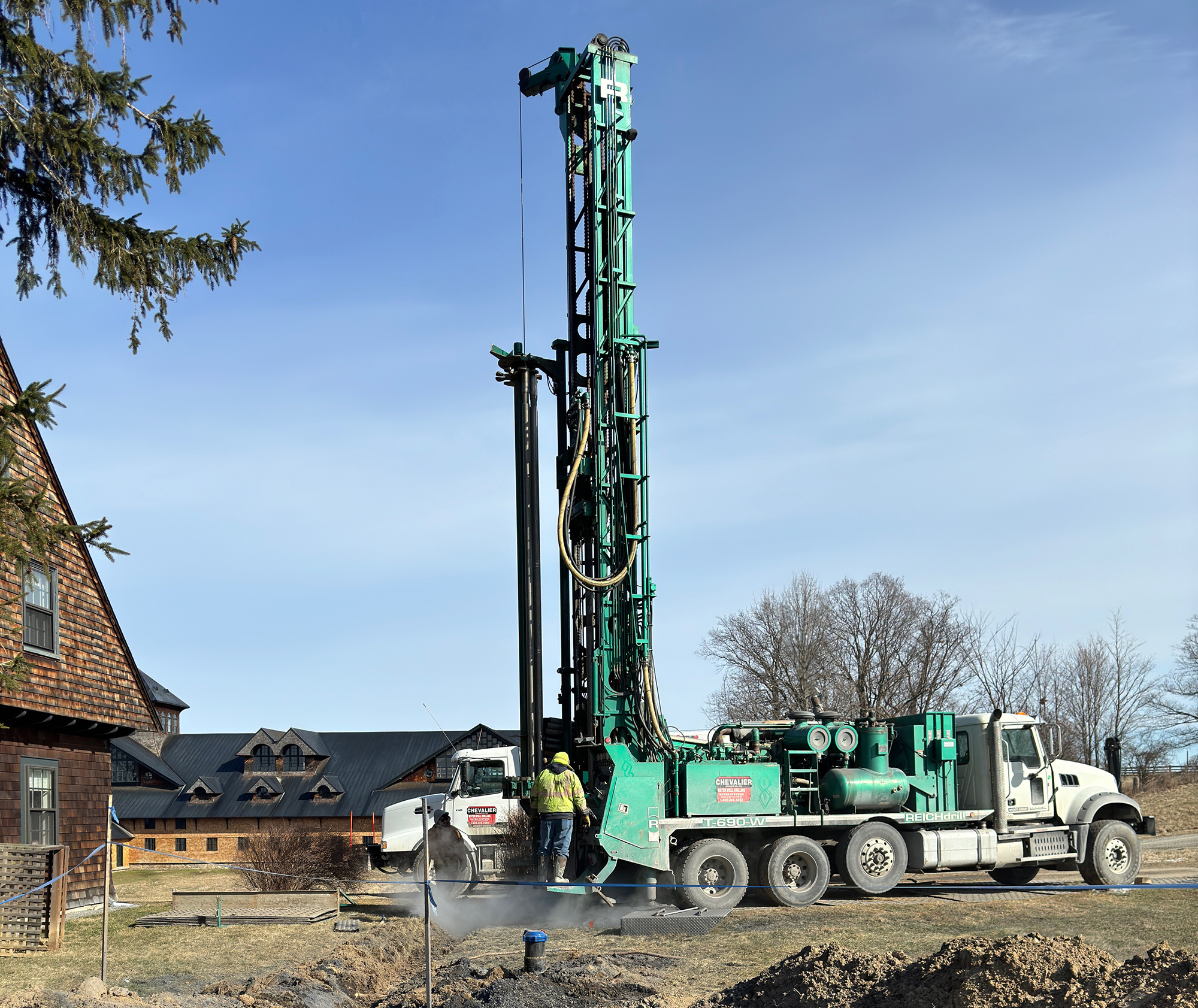 Very tall drill machine drilling a hole in the ground