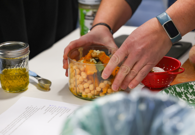 Sweet potato hummus ingredients in a manual food processor.